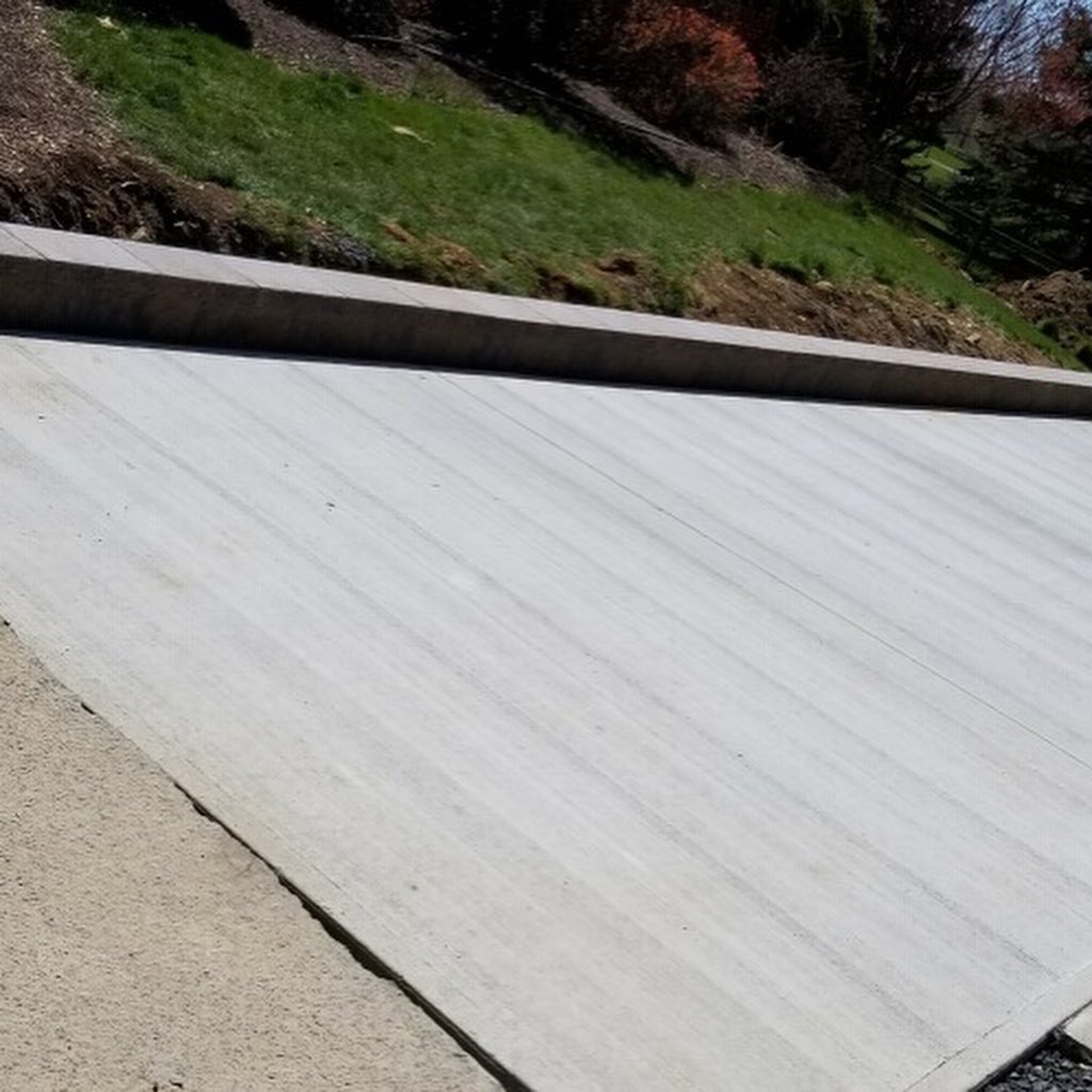 A freshly paved concrete driveway.