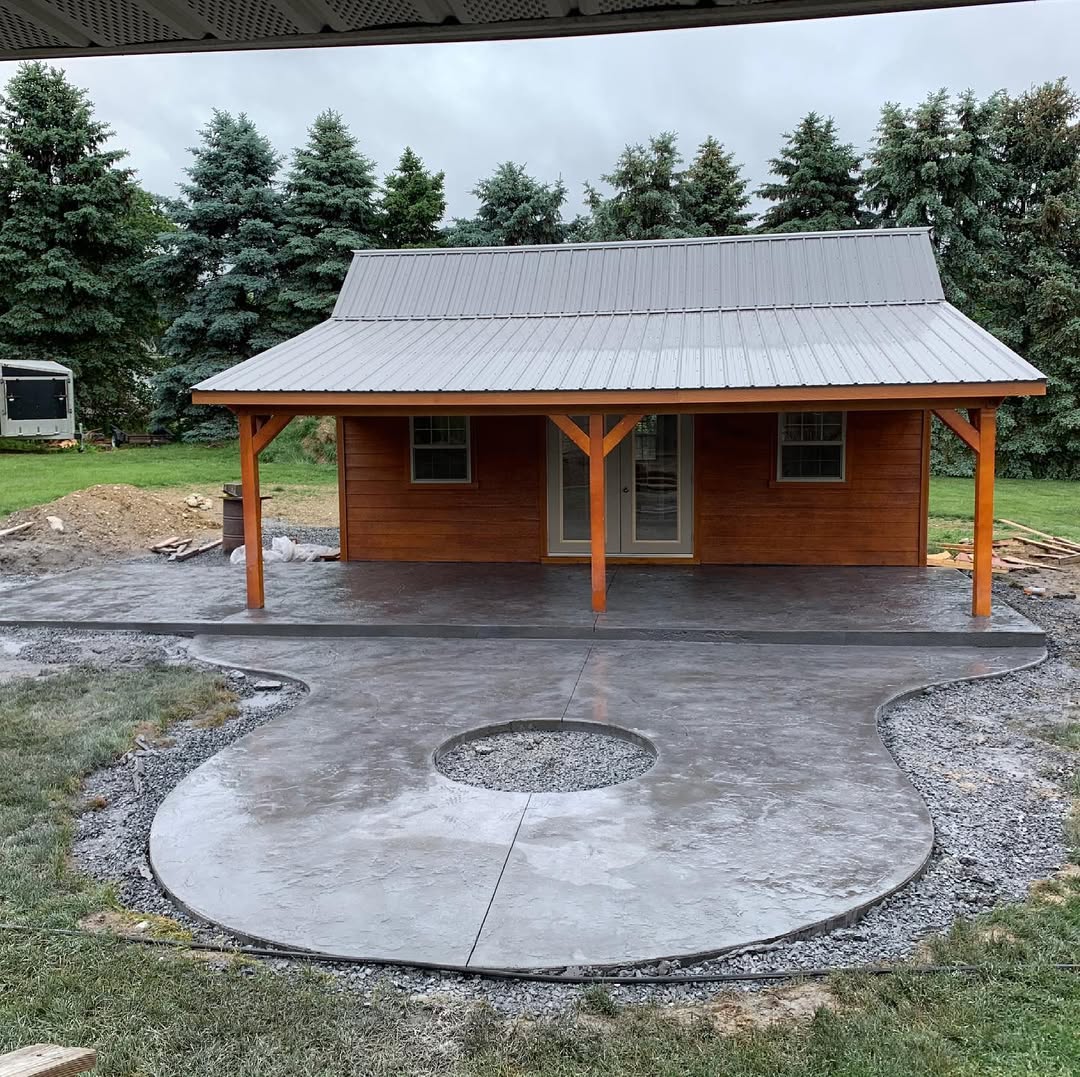 A concrete design outside of an outdoor shed.