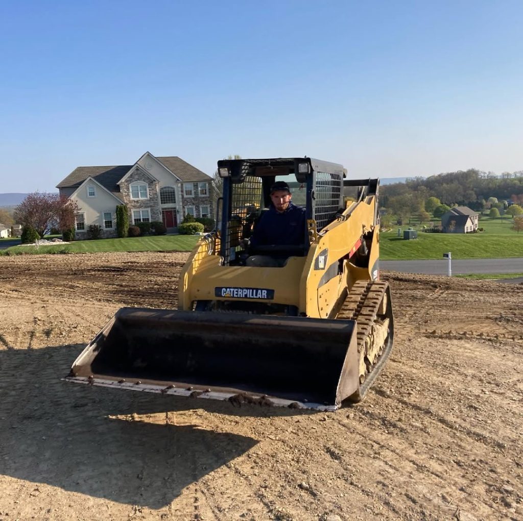 A man operating excavation equipment.