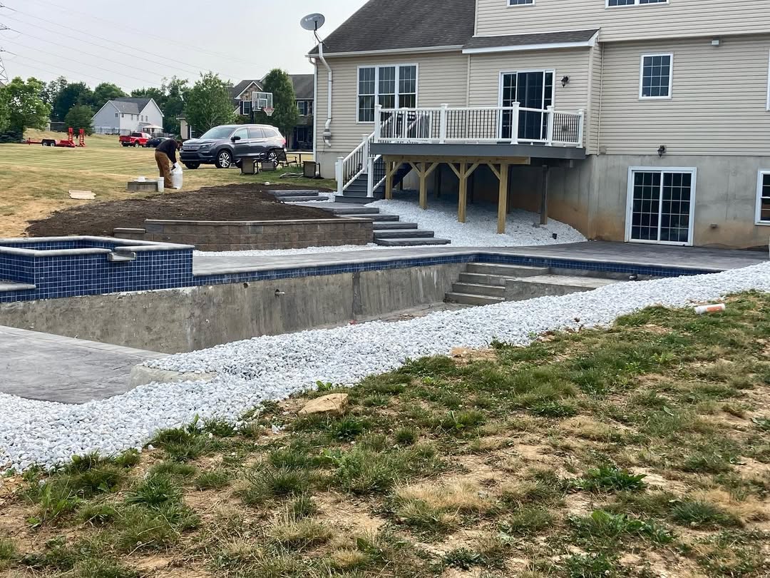 Concrete patio around a pool.