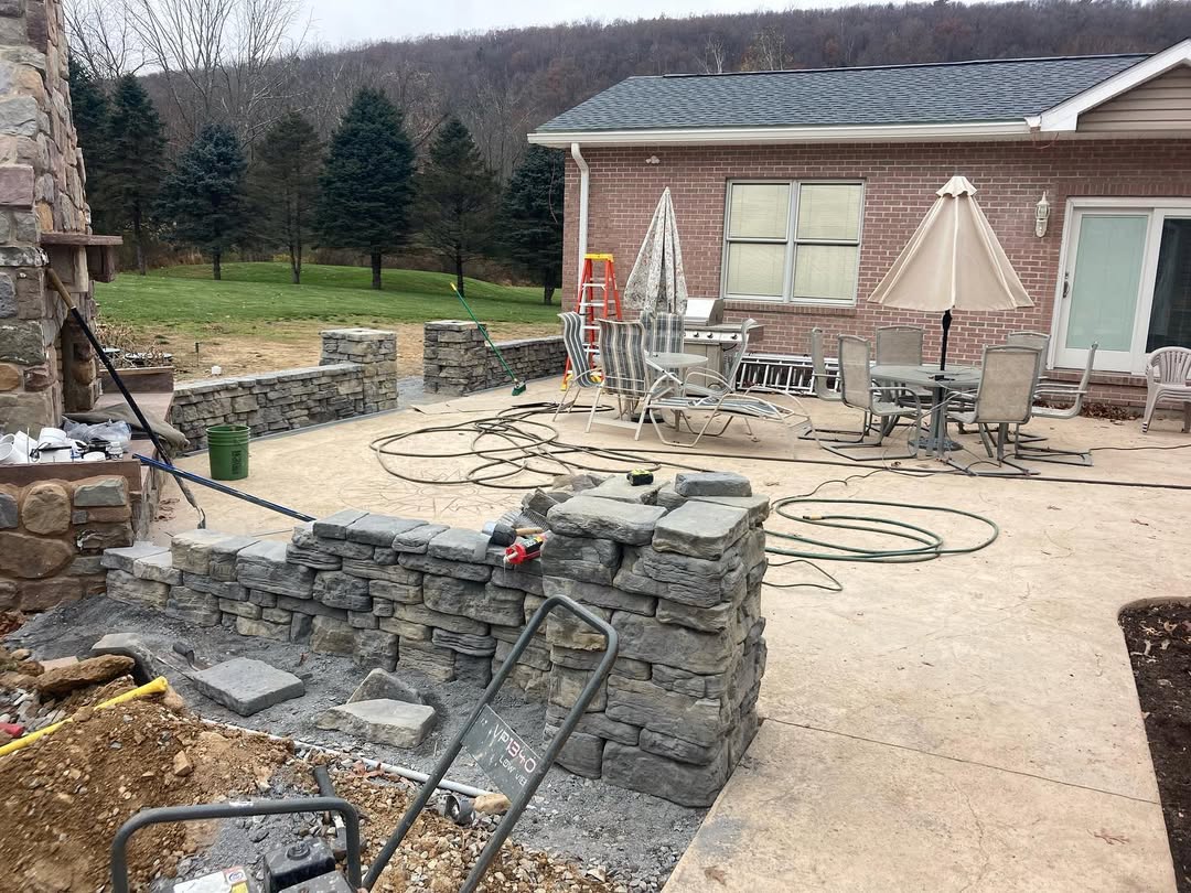 A stone wall in the process of being built.