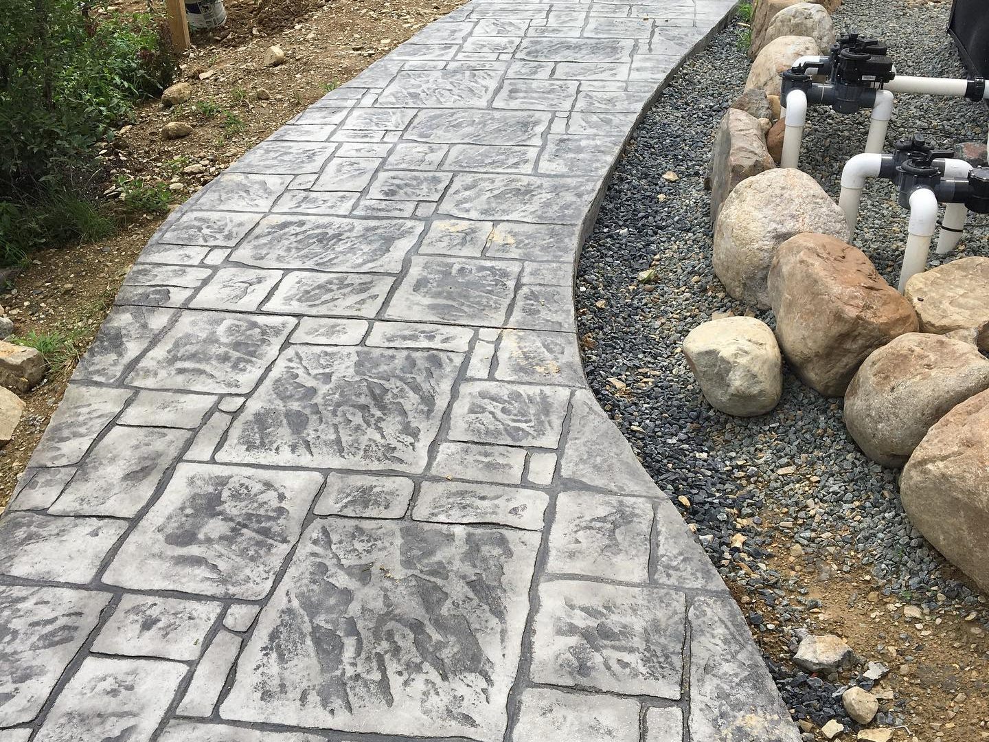A long concrete walkway showcasing a stamped pattern.